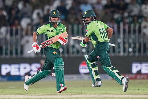 Pakistan's Ghazi Ghori, left, and Babar Azam run between the wickets to score during the first one day international cricket match between Pakistan and Australia, in Rawalpindi, Pakistan.