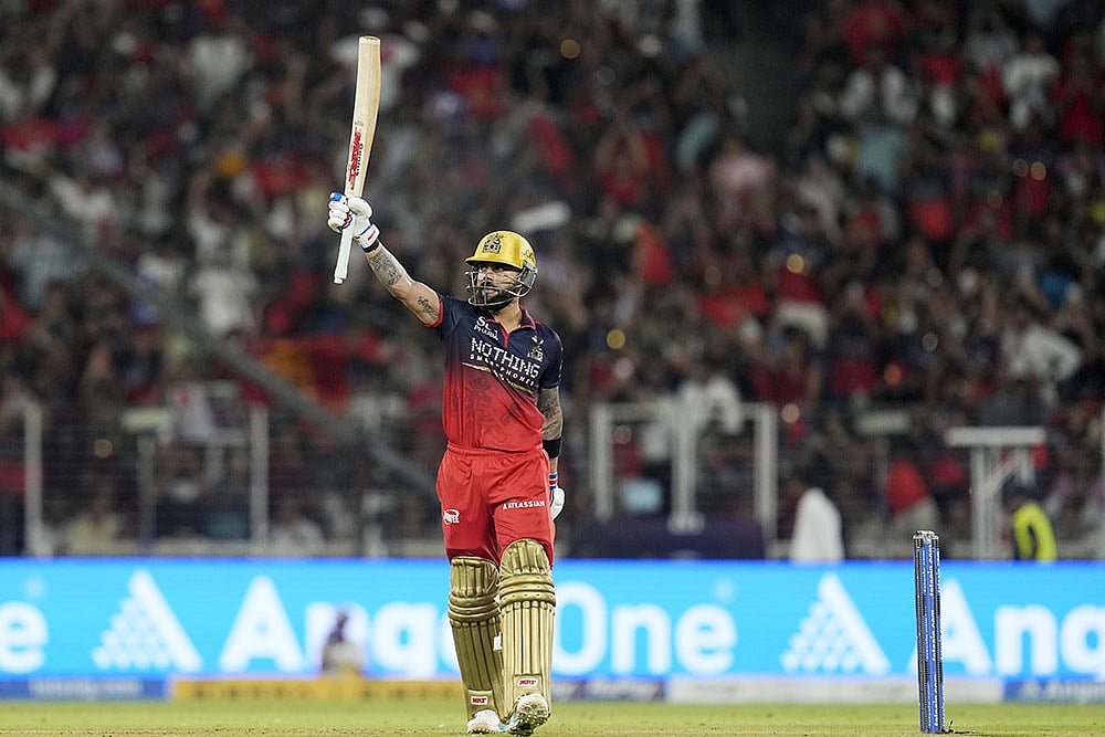 Royal Challengers Bengalurus Virat Kohli celebrates his half century 