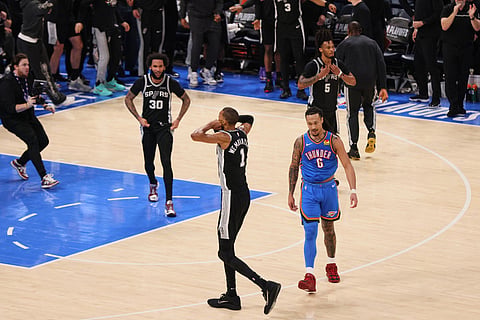 San Antonio Spurs forward Victor Wembanyama (1), forward Julian Champagnie (30), guard Stephon Castle (5) and Oklahoma City Thunder forward Jaylin Williams (6) react as time expires as the Spurs defeat the Thunder in Game 7 of the Western Conference finals of the NBA basketball playoffs series in Oklahoma City. 