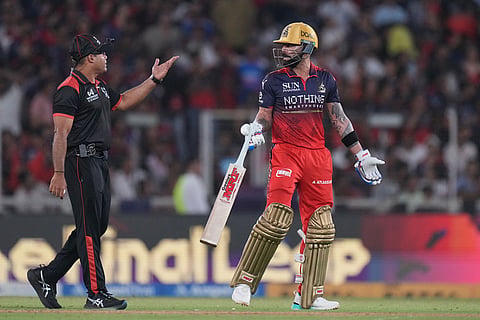 Royal Challengers Bengaluru's Virat Kohli talks to umpire after he was given out which was later reversed by third umpire during the Indian Premier League final cricket match between Gujarat Titans and Royal Challengers Bengaluru in Ahmedabad, India.