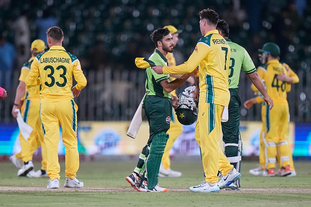 Pakistan's Arafat Minhas, center, shakes hand with Australia's Matt Renshaw on the end of the first one day international cricket match between Pakistan and Australia, in Rawalpindi, Pakistan. - | Photo: AP/Anjum Naveed