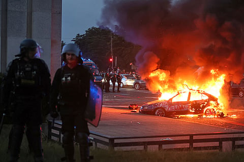 A car burns as PSG supporters celebrate in Paris, Saturday, May 30, 2026 after the Champions League final soccer match between Paris Saint-Germain and Arsenal that's being played in Budapest. PSG won the game.