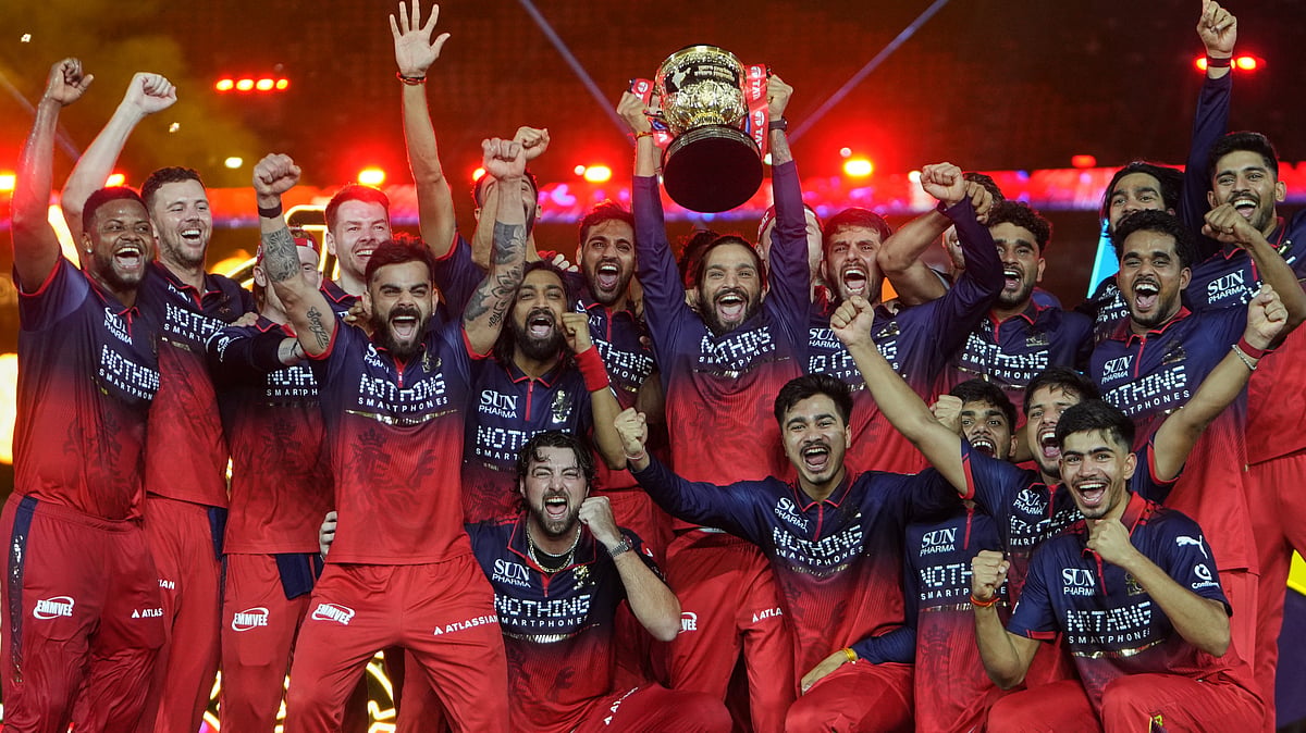 Royal Challengers Bengaluru players celebrate with winners trophy after their win in the Indian Premier League final cricket match against Gujarat Titans in Ahmedabad. - AP Photo