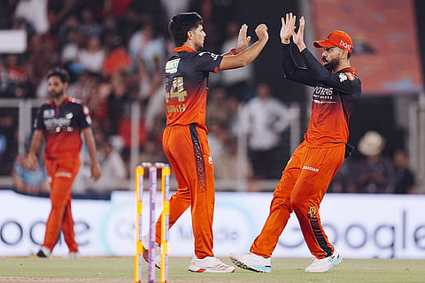 Royal Challengers Bengaluru's Rasikh Salam, left, celebrates with Virat Kohli after taking the wicket of Gujarat Titans' Nishant Sindhu during the Indian Premier League (IPL) 2026 Final T20 cricket match between Royal Challengers Bengaluru and Gujarat Titans, in Ahmedabad, Gujarat.