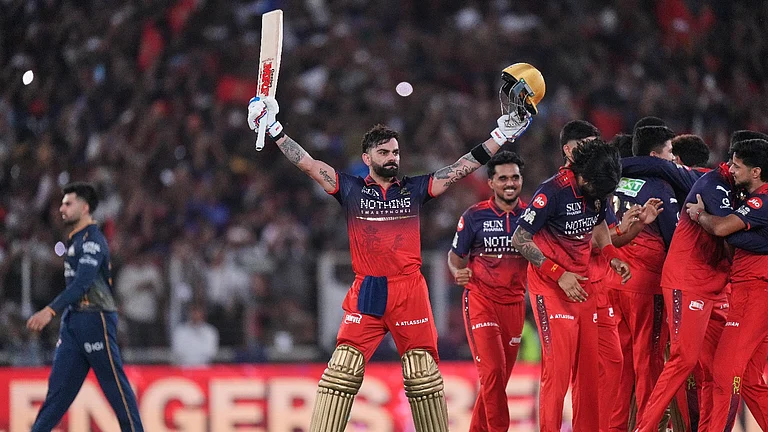 Royal Challengers Bengaluru's Virat Kohli celebrates with teammates after their win in the Indian Premier League final cricket match against Gujarat Titans in Ahmedabad. - AP Photo