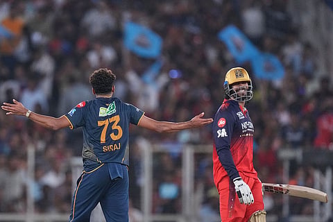 Gujarat Titans' Mohammed Siraj celebrates the wicket of Royal Challengers Bengaluru's Venkatesh Iyer, right, during the Indian Premier League final cricket match between Gujarat Titans and Royal Challengers Bengaluru in Ahmedabad, India.