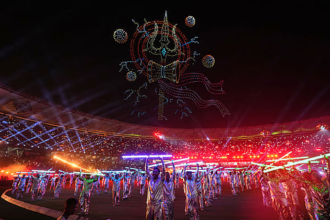 Artists perform as a laser show light up the sky during the Indian Premier League final cricket match between Gujarat Titans and Royal Challengers Bengaluru in Ahmedabad, India.