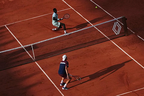 Alejandro Tabilo of Chile, bottom, plays against Moise Kouame of France during their third round men's singles tennis match at the French Open tennis tournament in Paris.