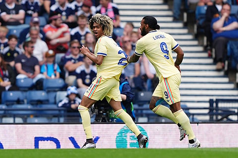 Curacao's Tahith Chong, left, celebrates scoring during an international friendly match between Scotland and Curacao in Glasgow.