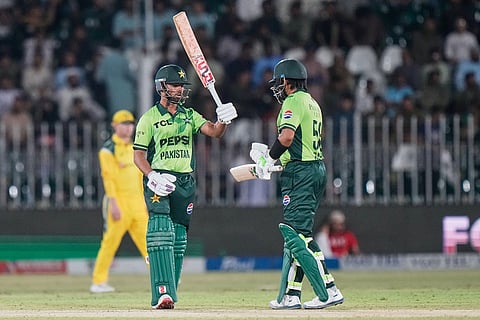 Pakistan's Ghazi Ghori, center, celebrates with Babar Azam after scoring fifty runs during the first one day international cricket match between Pakistan and Australia, in Rawalpindi, Pakistan.