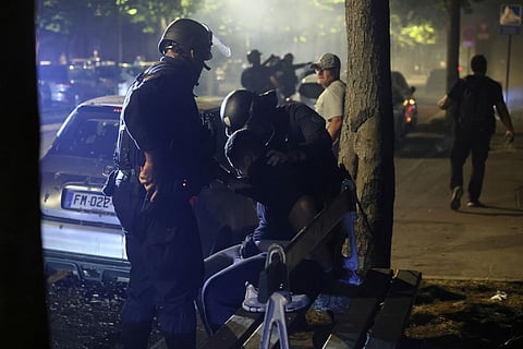 Police try to disperses PSG supporters who left off fireworks as they celebrate in Paris, Saturday, May 30, 2026 after the Champions League final soccer match between Paris Saint-Germain and Arsenal that was played in Budapest. PSG won the game.