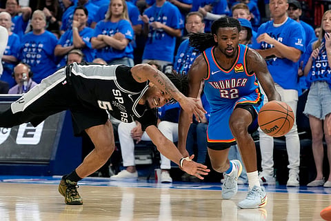 Oklahoma City Thunder guard Cason Wallace (22) dribbles the ball as San Antonio Spurs guard Stephon Castle (5) defends during the second half of Game 7 of the Western Conference finals of the NBA basketball playoffs series in Oklahoma City.