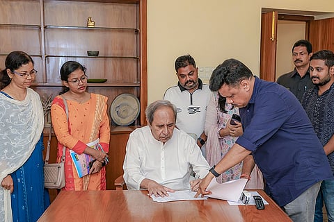 In this image received on May 31, 2026, Biju Janata Dal President Naveen Patnaik signs the enumeration form for the Special Intensive Revision (SIR), in Bhubaneswar.
