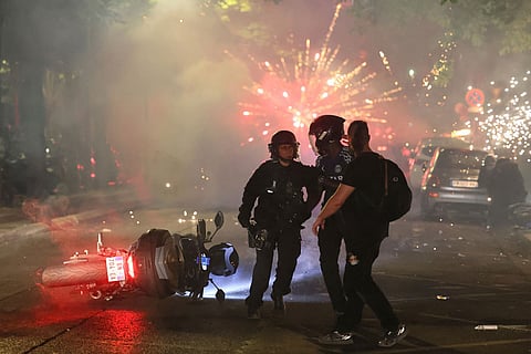 Police try to disperses PSG supporters who left off fireworks as they celebrate in Paris, Saturday, May 30, 2026 after the Champions League final soccer match between Paris Saint-Germain and Arsenal that was played in Budapest. PSG won the game.
