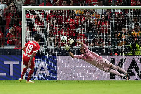 Tigres' goalkeeper Nahuel Guzman, right, fails to blocks a shot by Toluca's Santiago Simon during a penalty shootout on the CONCACAF Champions Cup final soccer match in Toluca, Mexico.