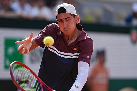 Alejandro Tabilo of Chile returns to Moise Kouame of France during their third round men's singles tennis match at the French Open tennis tournament in Paris.
