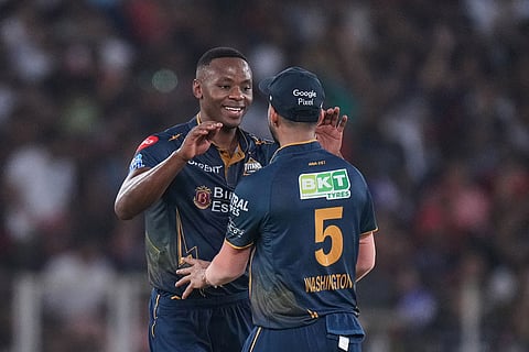 Gujarat Titans' Kagiso Rabada celebrates the wicket of Royal Challengers Bengaluru's Devdutt Padikkal with with teammate Washington Sundar during the Indian Premier League final cricket match between Gujarat Titans and Royal Challengers Bengaluru in Ahmedabad, India.