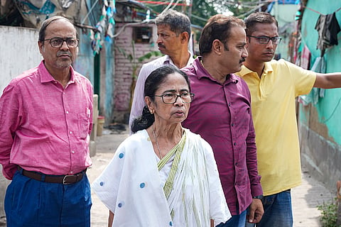 TMC supremo Mamata Banerjee walks towards the residence of party MP Kalyan Banerjee, at Kalighat in Kolkata. Kalyan claimed he suffered head injuries after being mobbed in front of a police station he visited in West Bengal's Hooghly district on Sunday to submit a memorandum against the arrest of party workers after the Assembly elections.