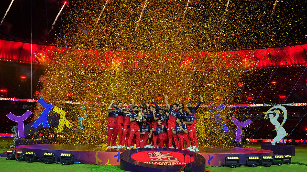 Royal Challengers Bengaluru players celebrate with winners trophy after their win in the Indian Premier League final cricket match against Gujarat Titans in Ahmedabad, India, Monday, June 1, 2026 - (AP Photo/Ajit Solanki)
