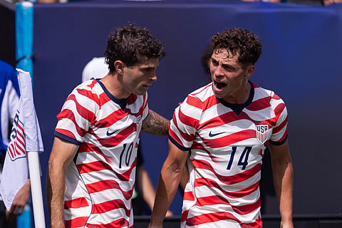 United States forward Christian Pulisic (10) celebrates with midfielder Sebastian Berhalter (14) after scoring in the first half against Senegal in an international friendly soccer  in Charlotte, N.C.