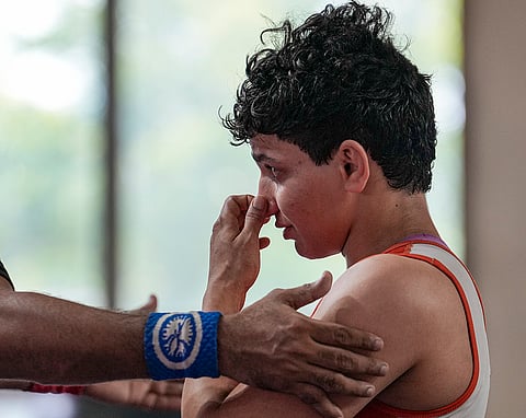 Nishu reacts after losing a 53kg category wrestling match against Vinesh Phogat during the Asian Games selection trials, in New Delhi.
