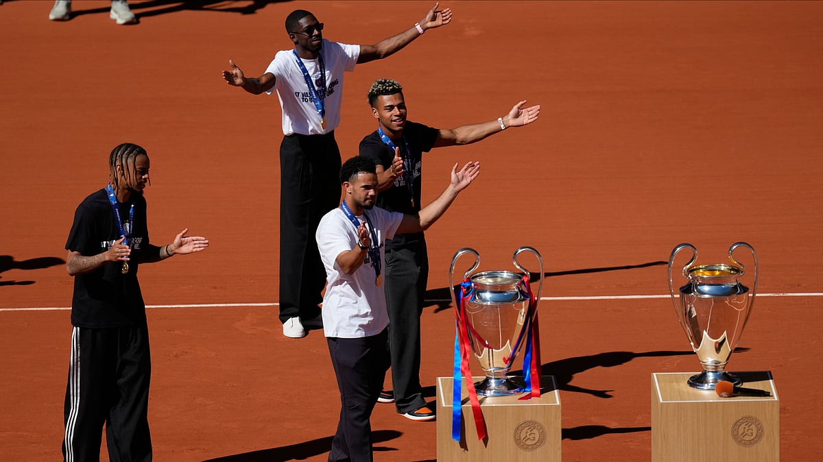 Paris Saint-Germain players Bradley Barcola, left. Warren Zaire-Emery, center, Desire Doue, right, and Ousmane Dembele present two Champions League trophies at the French Open in Paris, Monday, June 1, 2026.