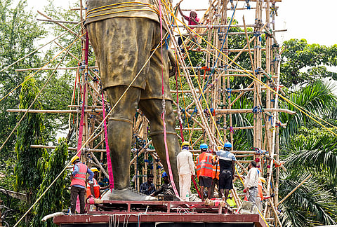 PWD workers use a crane to dismantle a statue of Argentine footballer Lionel Messi, in Kolkata.