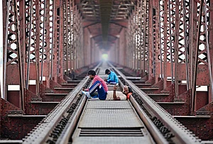 | Photo: PTI : Prayagraj: People rest on the railway track of the Lord Curzon Bridge over River Ganga on a hot summer day, in Prayagraj.