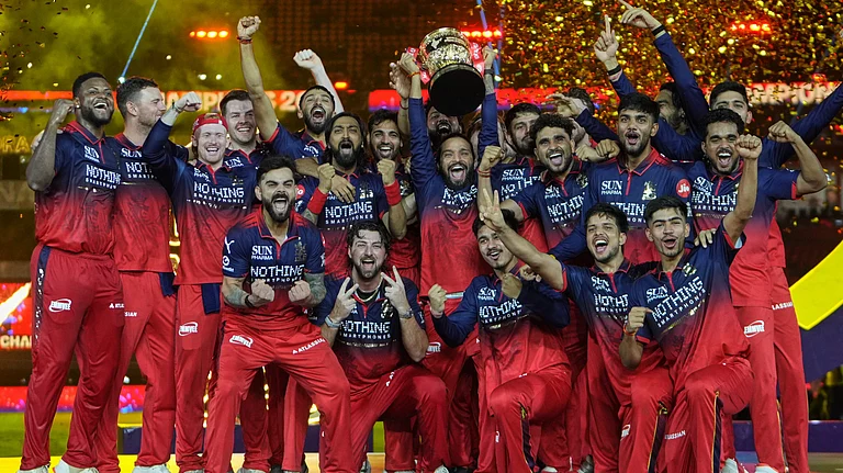 Royal Challengers Bengaluru players celebrate with winners trophy after their win in the Indian Premier League final cricket match against Gujarat Titans in Ahmedabad, India, Monday, June 1, 2026 - (AP Photo/Ajit Solanki)