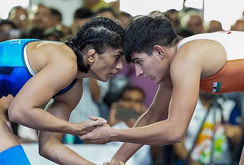 Vinesh Phogat, in blue, competes against Jyoti in a 53kg category wrestling match during the Asian Games selection trials, in New Delhi.