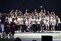 PSG UEFA Champions League 2025-26 Trophy Parade: See Best Photos From Paris Saint-Germain's Title Celebrations | Photo: AP/Emma Da Silva : PSG members celebrate at Parc des Princes stadium in Paris, after the team won the Champions League final against Arsenal in Budapest.