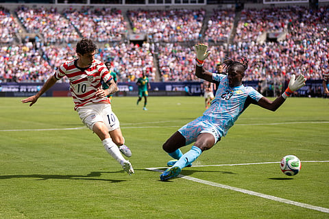 United States forward Christian Pulisic (10) shoots past Senegal forward Cherif Ndiaye (23) during the first half of an international friendly soccer match in Charlotte, N.C.