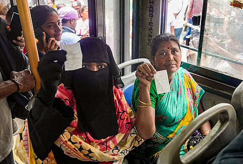 Women passengers show their tickets after the statewide free bus travel scheme for women comes into effect, in Kolkata.