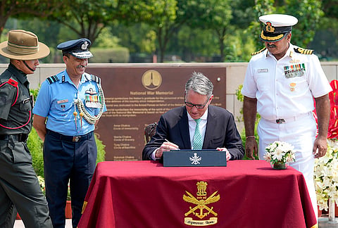 Australian Deputy Prime Minister and Defence Minister Richard Marles signs the visitor's book, at the National War Memorial in New Delhi.
