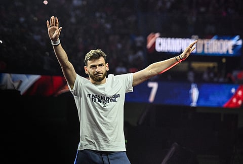 PSG's Khvicha Kvaratskhelia celebrates at Parc des Princes stadium in Paris, after the team won the Champions League final against Arsenal in Budapest. 