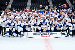 | Photo: AP/Darko Bandic : Finland players celebrate with trophy after winning the 2026 IIHF Men's Ice Hockey World Championship final match against Switzerland, in Zurich, Switzerland.