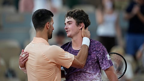 Novak Djokovic of Serbia, left, and Joao Fonseca of Brazil hug after their third round men's singles tennis match at the French Open tennis tournament in Paris, Friday, May 29, 2026.