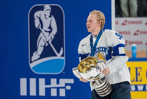Finland's Konsta Helenius, scorer of the game winning goal, celebrates with the trophy after the gold medal ice hockey match between Finland and Switzerland at the 2026 IIHF Men's Ice Hockey World Championship in Zurich, Switzerland.