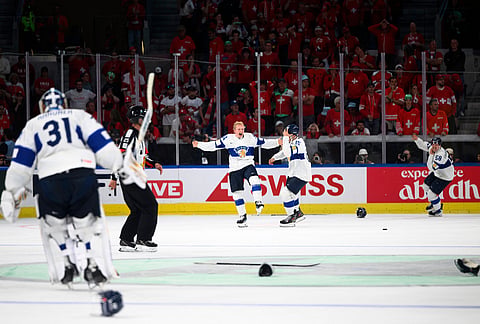 Finland's Konsta Helenius, center, celebrates after scoring the winning goal in extra time in the gold medal ice hockey match between Finland and Switzerland at the 2026 IIHF Men's Ice Hockey World Championship in Zurich, Switzerland.