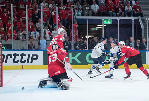 Finland's Konsta Helenius, second right, scores his side's opening goal during the 2026 IIHF Men's Ice Hockey World Championship final match between Switzerland and Finland, in Zurich, Switzerland.
