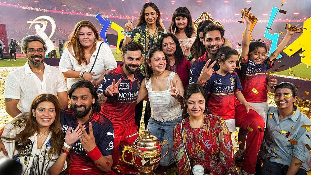 Royal Challengers Bengaluru's players and their family members celebrate with the tournament trophy after the team won the Indian Premier League (IPL) 2026 title, in Ahmedabad, Gujarat. - Photo: PTI/Ravi Choudhary