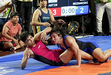 | Photo: PTI/Kamal Kishore : Wrestlers Antim Panghal, in red, and Meenakshi Goyat compete in the women's 53kg category final wrestling match during the Asian Games selection trials, in New Delhi.