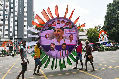 Bengaluru: Workers carry an installation with a portrait of Karnataka CM-designate DK Shivakumar amid preparations on the eve of the swearing-in ceremony of the new state government, in Bengaluru.