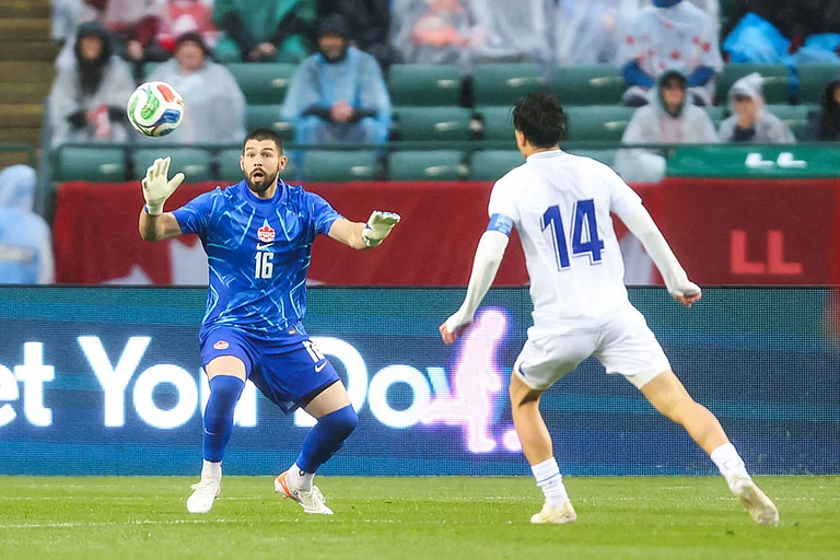 Canada goalkeeper Maxime Crepeau (16) makes a save against Uzbekistan's Eldor Shomurodov (14) during the first half of an international friendly soccer match in Edmonton, Alberta. - | Photo: Codie McLachlan/The Canadian Press via AP