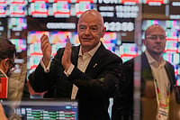 Photo: AP/Tony Gutierrez : FIFA President Gianni Infantino, center, applauds as operations are started inside the Master Control Room during the opening ceremony of the International Broadcast Center in Dallas.
