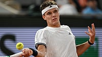 AP : Czech Republic's Jakub Mensik returns to Brazil's Joao Fonseca during the quarterfinal tennis match at the French Open in Paris, Tuesday