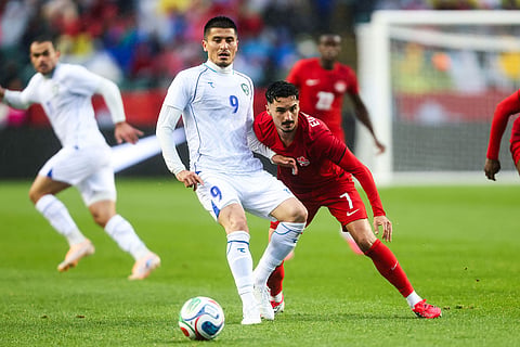 Canada's Stephen Eustaquio (7) battles against Uzbekistan's Odiljon Xamrobekov (9) during the first half of an international friendly soccer match in Edmonton, Alberta.