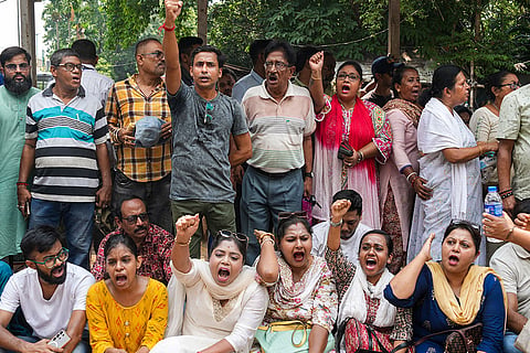 TMC supporters during a sit-in protest against the alleged attacks on party leaders and workers, in Kolkata, West Bengal.