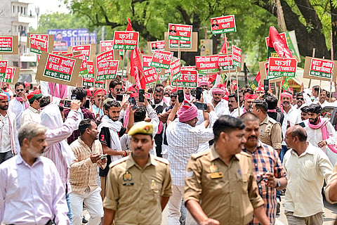 Police personnel keep vigil as Samajwadi Party workers protest against the BJP-led government over the alleged NEET paper leak and the hike in LPG, diesel and petrol prices, in Prayagraj, Uttar Pradesh.