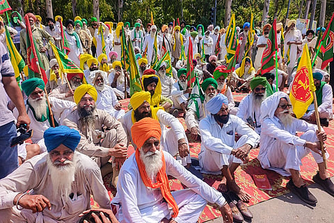 Farmers block a road as they stage a protest against the central government over various pending demands, in Patiala, Punjab,